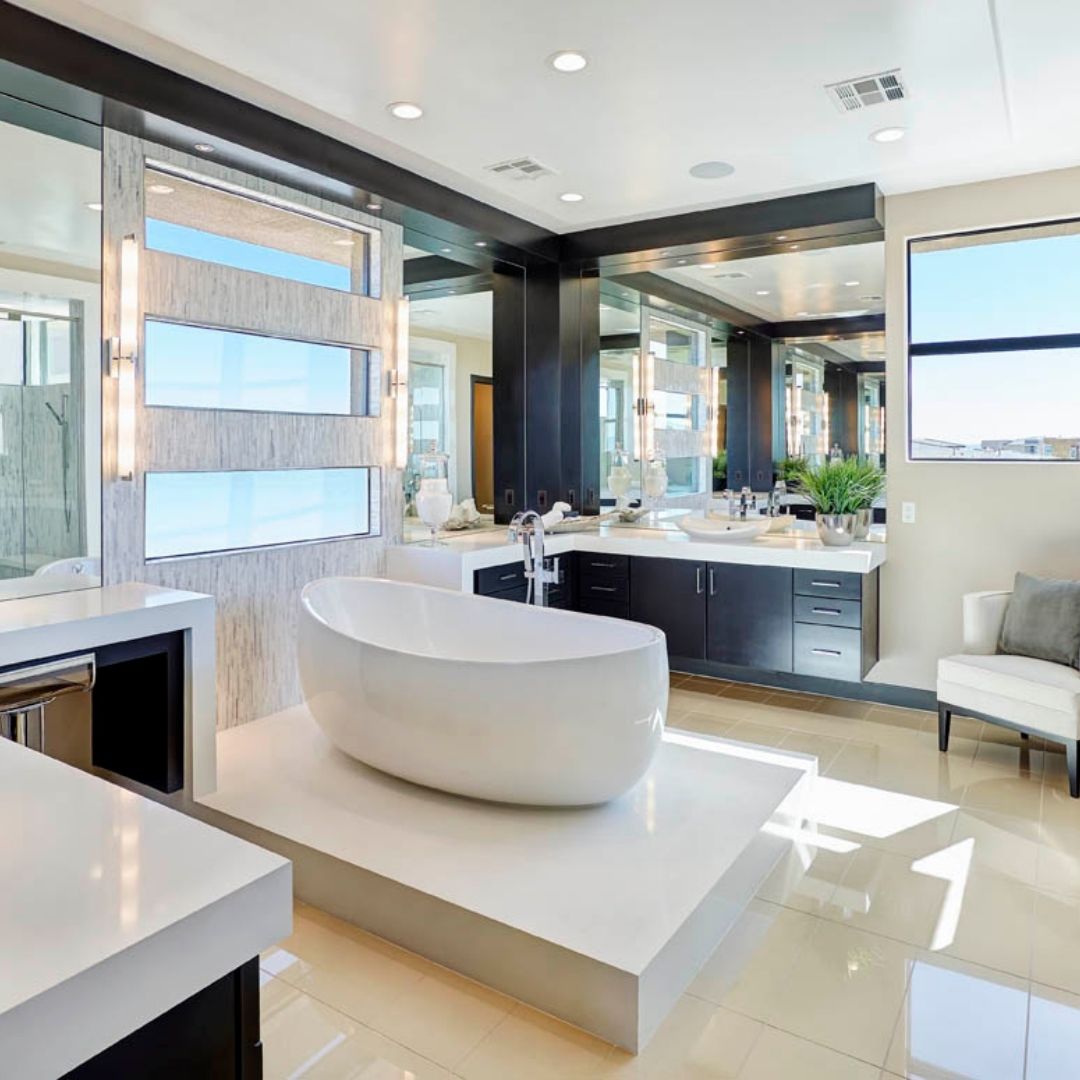 A remodeled bathroom with standing tub in the center