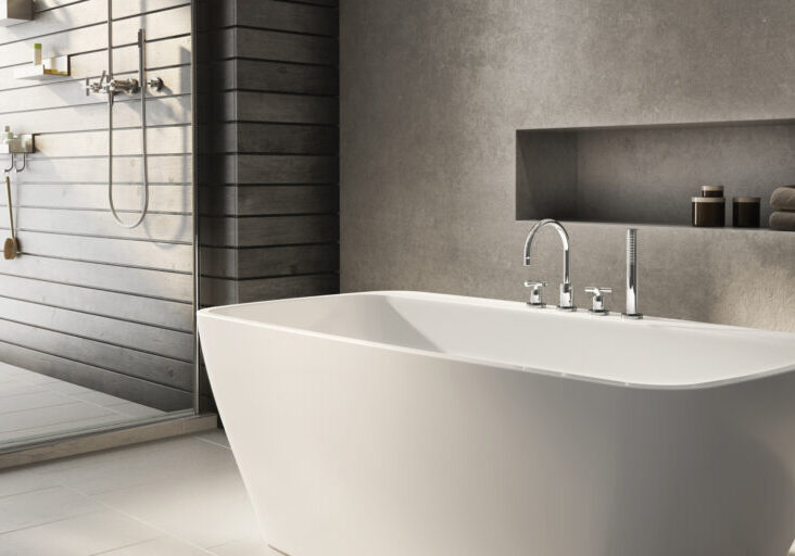 gray walls surrounding white bathtub