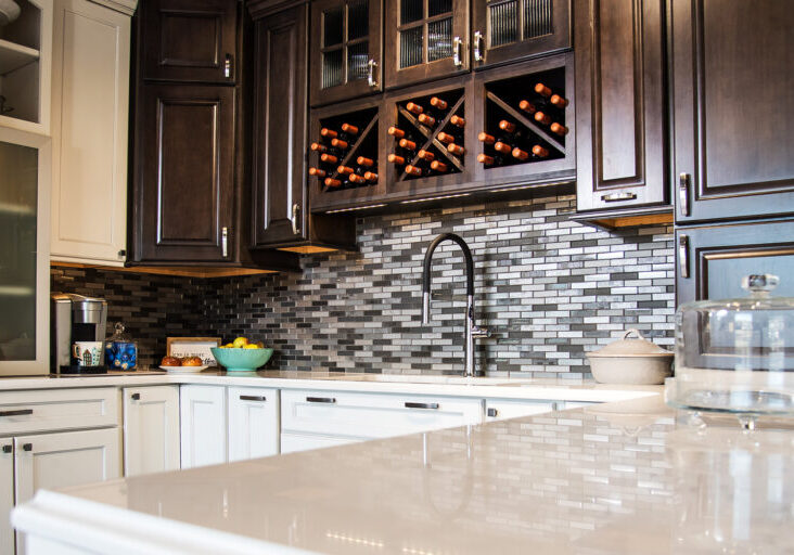 white countertop with dark cabinets and dark backsplash
